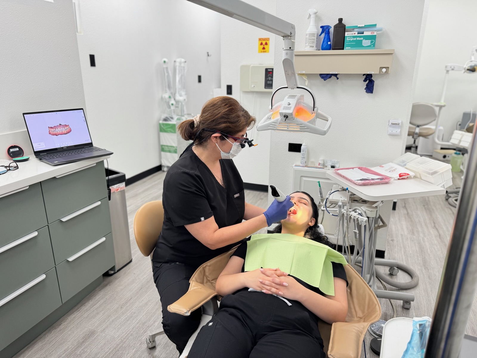 A patient receiving care in a treatment room at Oakridge Dental